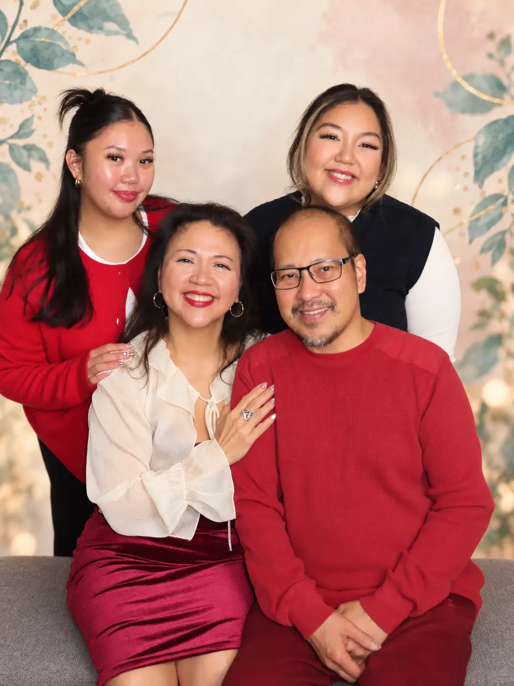 Gina Marie smiling with her husband and daughters